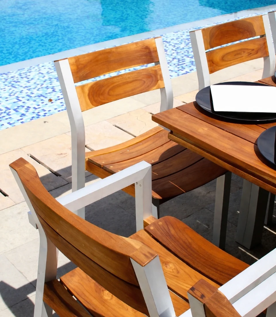Silla Bretaña en teca y aluminio junto a piscina
