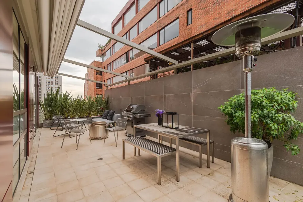 el mismo extremo de la terraza con la pérgola retráctil recogida y la estructura a la vista
