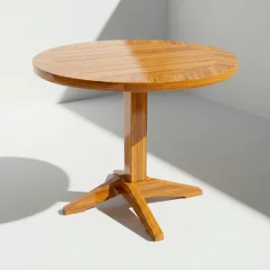 Mesa Putumayo circular en madera teca sobre base de pedestal con pie en cruz, vista frontal