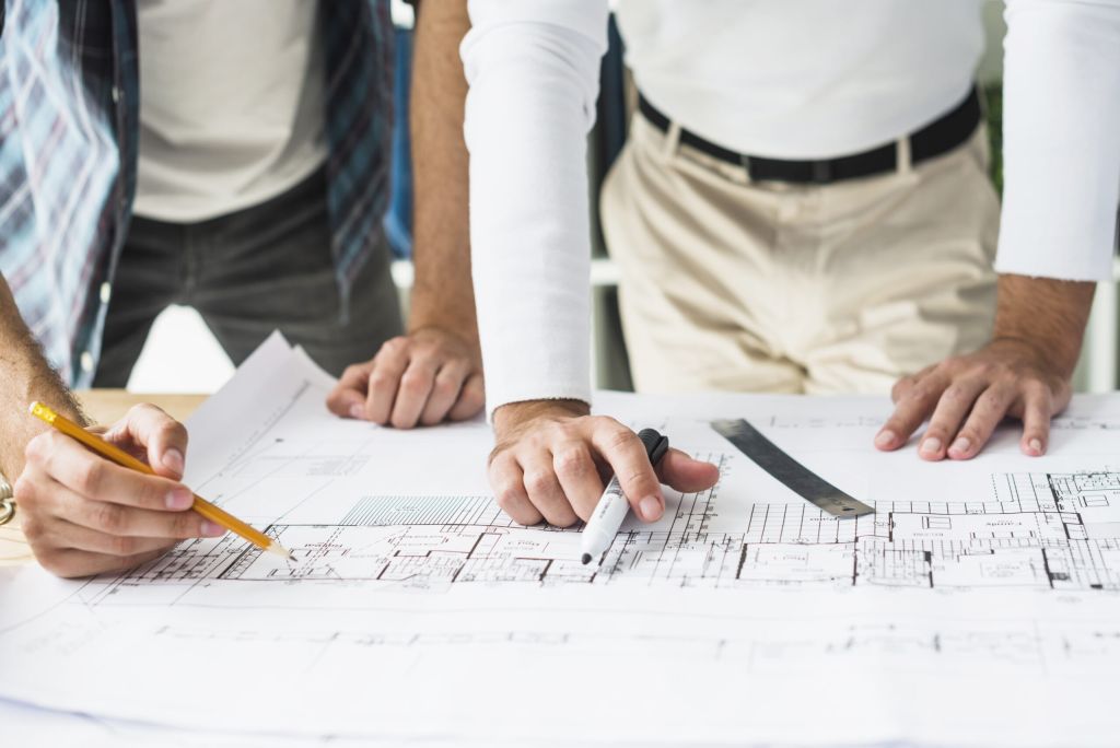 Close up two male architect hand blueprint — Pérgola: aliado perfecto en construcción 2025