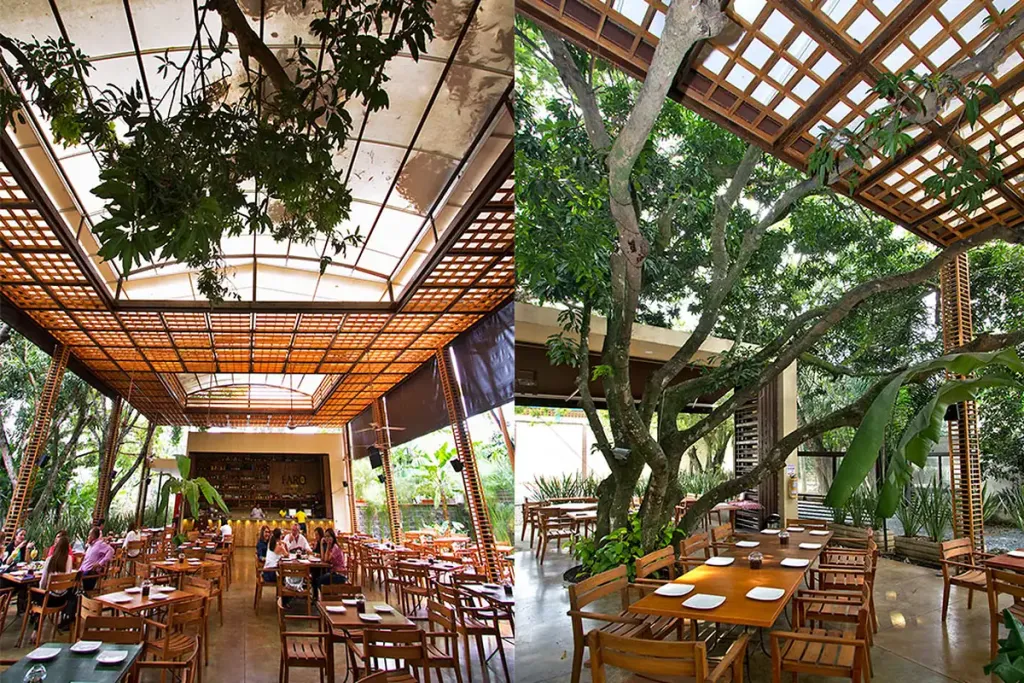 Pérgola fija de acero sobre la terraza del restaurante Faro, con lámparas colgadas de la estructura