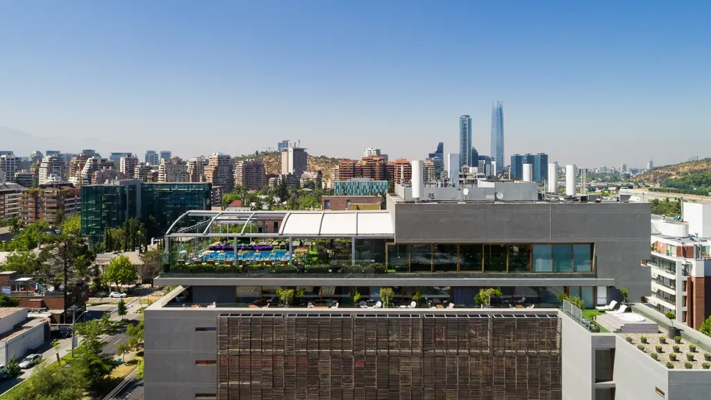 Vista aérea de la azotea del hotel Noi con la pérgola PergoDom y la ciudad al fondo